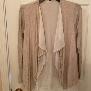 Cream colored certifiable with white ruffles, size small.